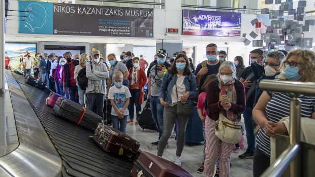 Los pasajeros esperan para recoger su equipaje en el Aeropuerto Internacional Nikos Kazantzakis de Heraklion, en la isla de Creta, ...